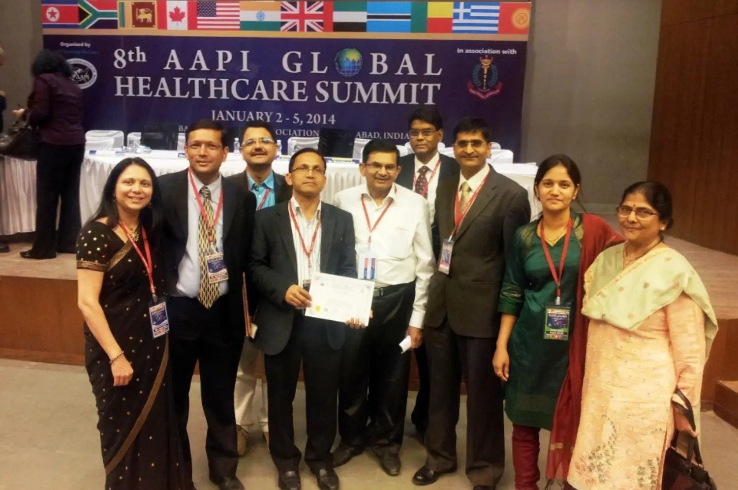 Man and woman speaking on stage at night with blue lighting