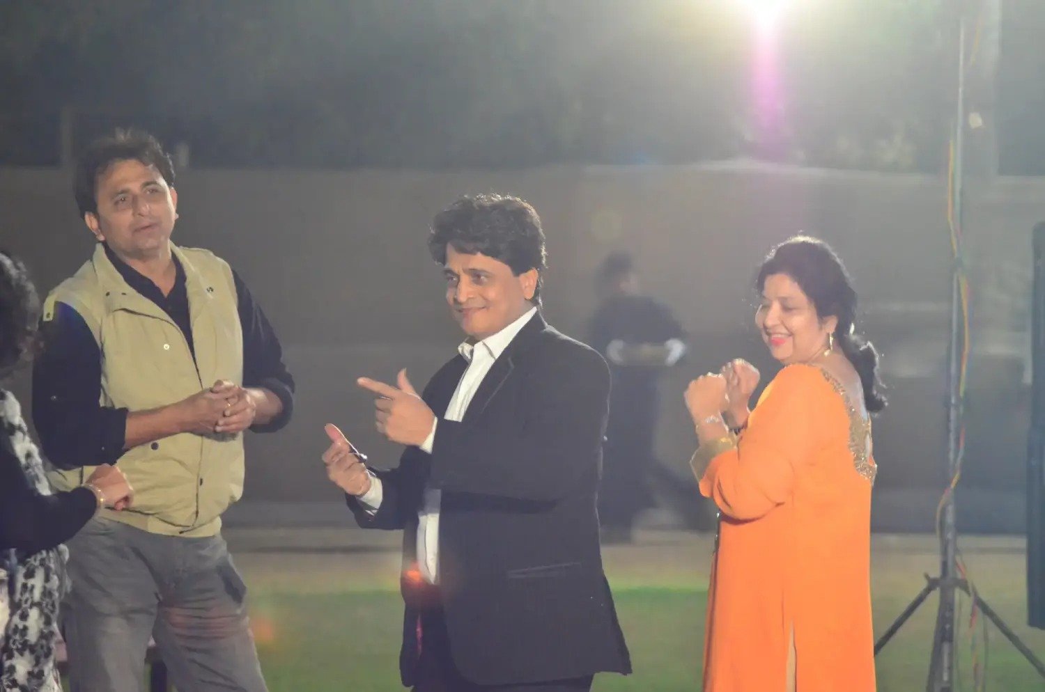 Balloon arch in orange, black, and white colors framing an ITT logo board lit with warm lights