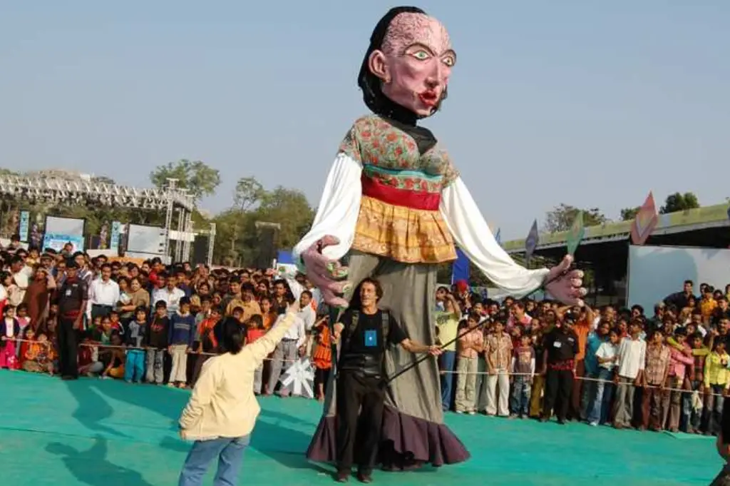 ITT event entrance with red and green carpet and pink lighting on white structure with ITT branding