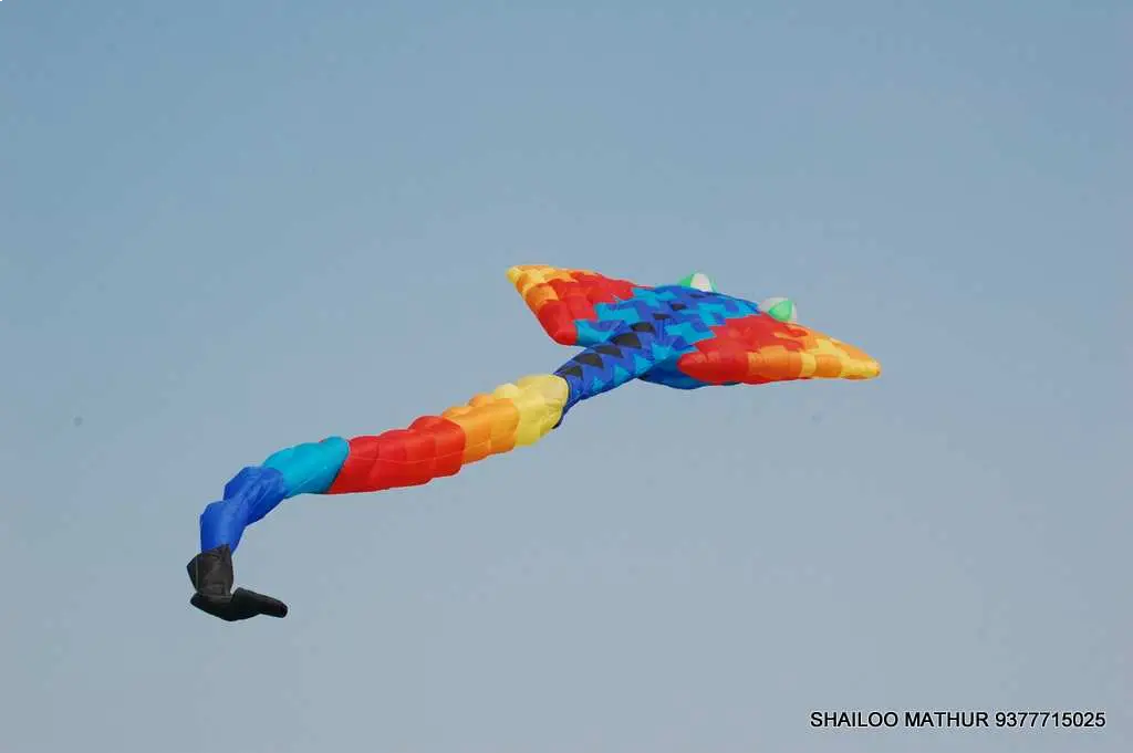 Men lighting ceremonial lamp at event with ITT banner in background