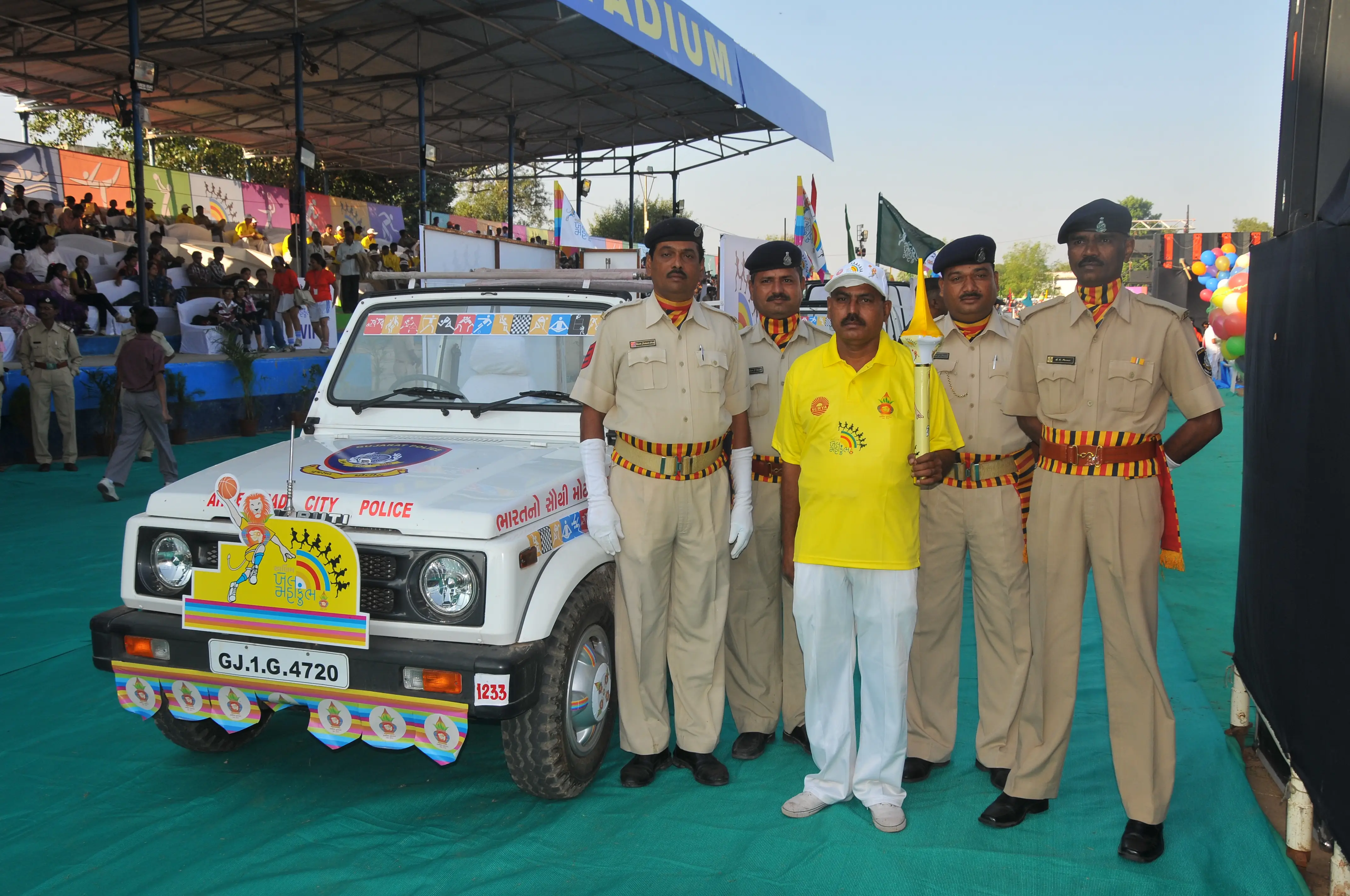 Group of men posing with large cartoon character inflatable figures at night outdoors