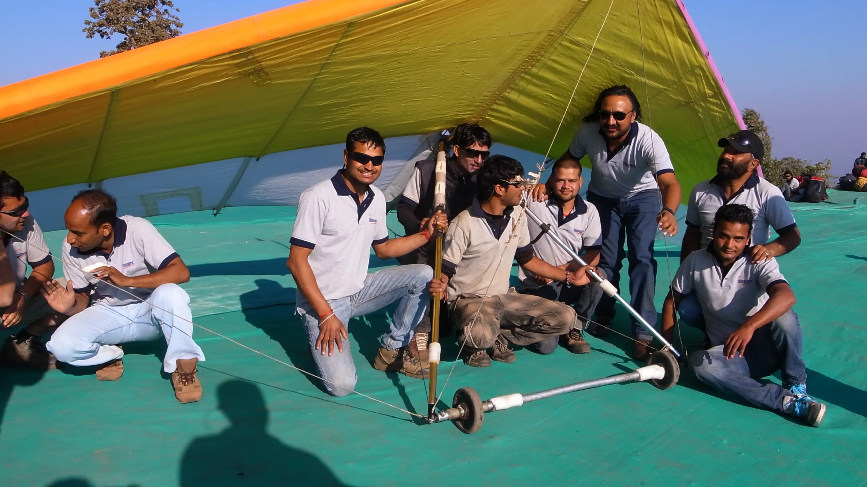 Men lighting ceremonial lamp at event with ITT banner in background